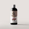 A bottle of Rejuva Kare Natural Conditioner with a label featuring a pink flower.