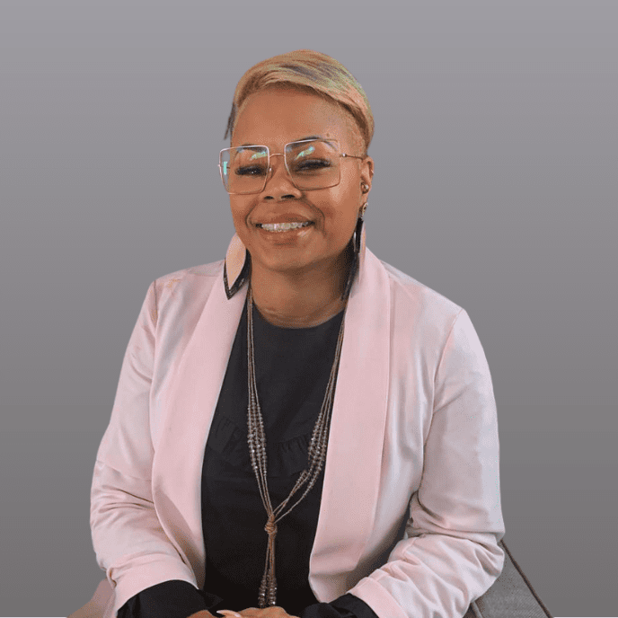 A headshot of a smiling woman wearing glasses.