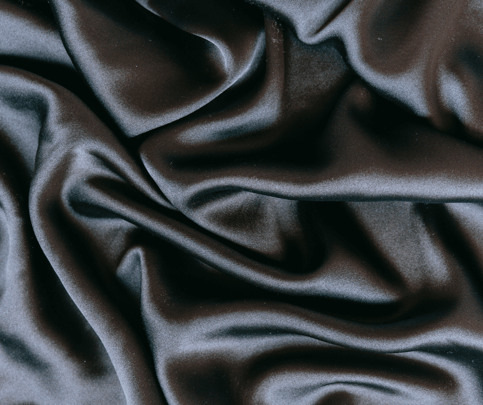 Close-up of smooth black satin fabric.