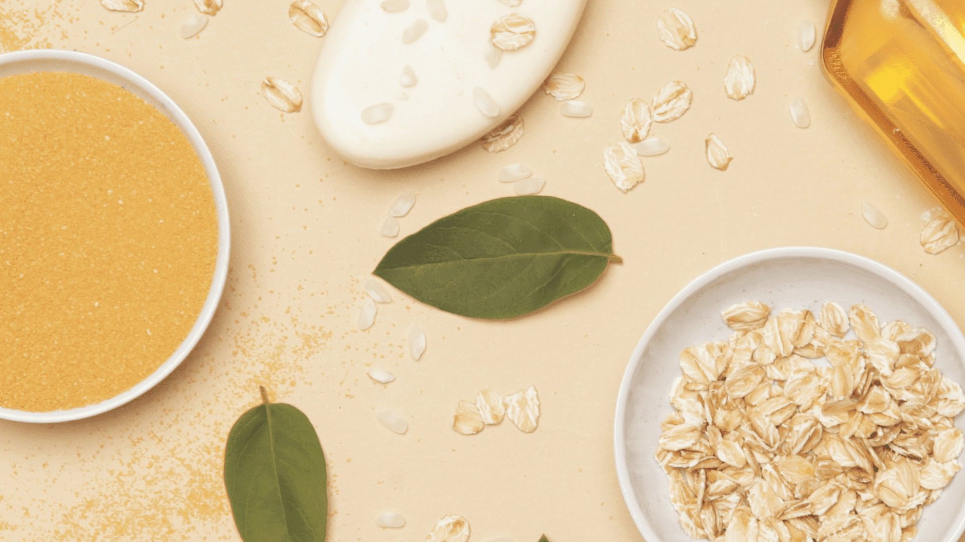 Oatmeal, soap, and leaves on a beige background.